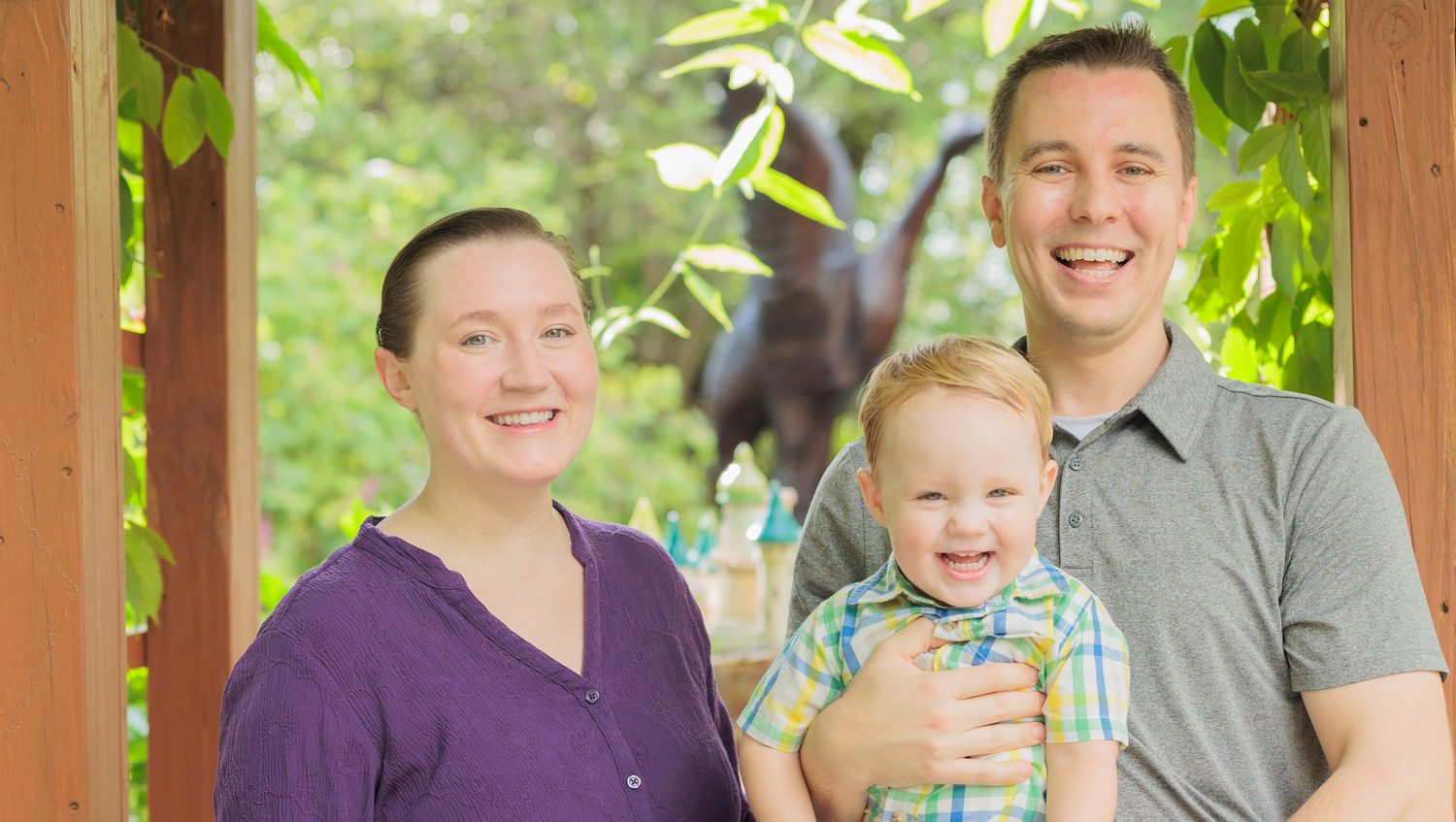 Jordan with his wife and son outdoors