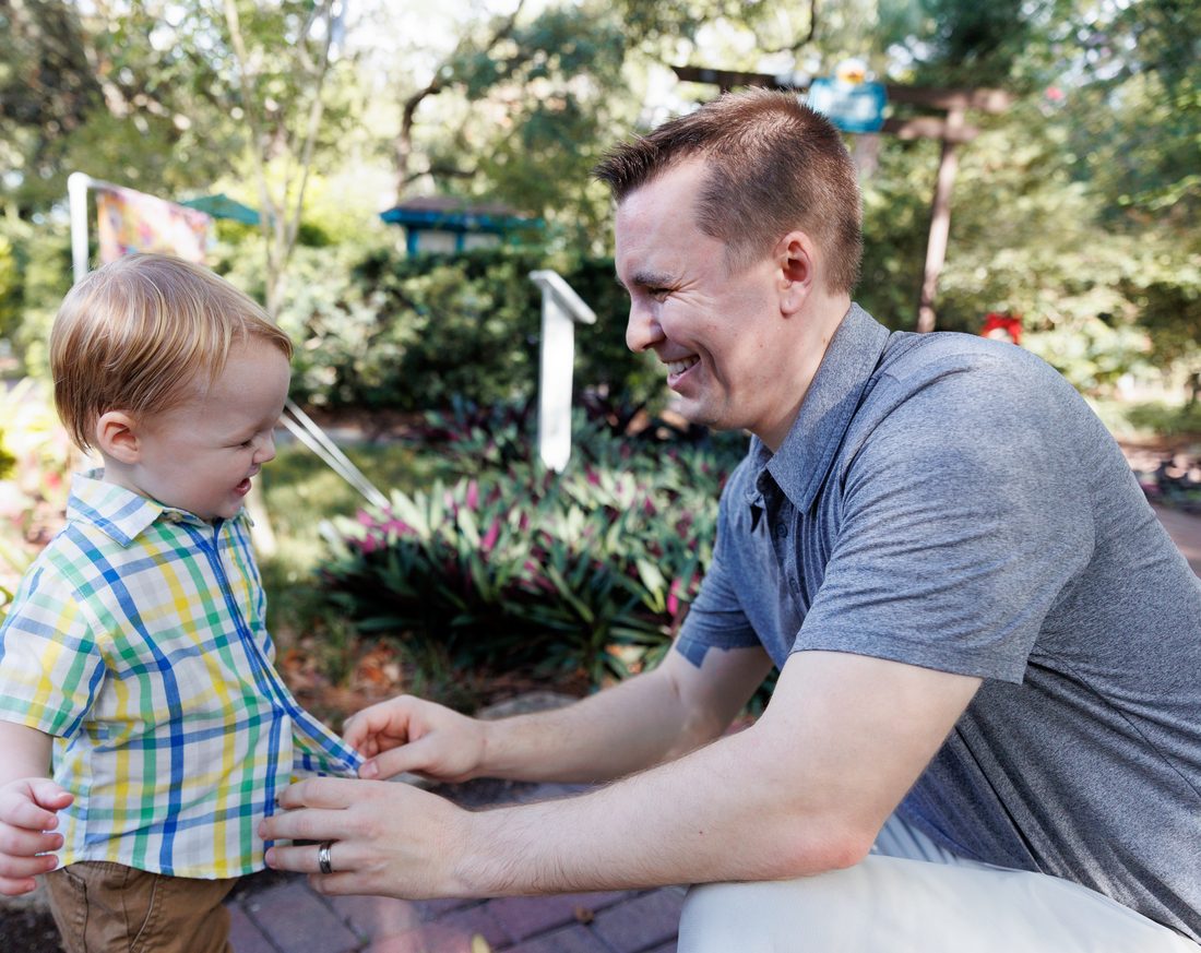 Jordan crouched down laughing with his son